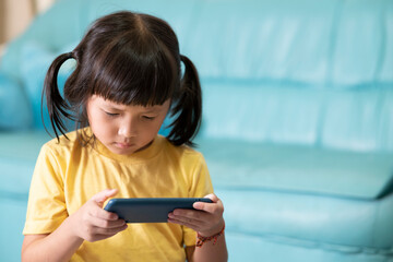 Tired eyes and fatigue from using the phone for a long time,child playing online games. Internet or...