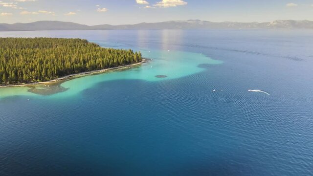 Drone flying towards Sugar Pine State Park in Lake Tahoe California. super  clear water reveals the rocks below.