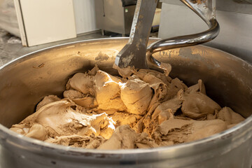 Industrial mixer for kneading dough. One of stages of making bread dough. Preparation of the...