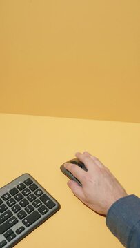 Hand using computer mouse on studio background - Vertical Video