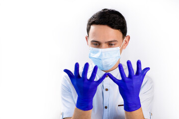 The guy in the medical mask and gloves. Virus protection. Precautionary Methods. Doctor on a white background. Blue medical gloves.