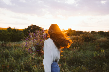 Healing Power of Nature, Benefits Of Ecotherapy, Nature Impact Wellbeing. Happy young girl holding wildflowers bouquet, relaxing and enjoying life