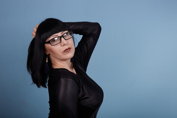 portrait of a beautiful girl with glasses posing for a photographer in the studio