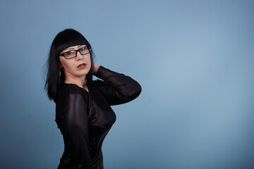portrait of a beautiful girl with glasses posing for a photographer in the studio