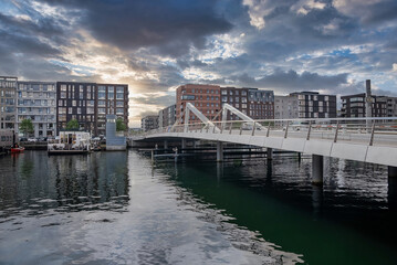 Fototapeta premium Beautiful canals of Copenhagen, the capital of Denmark. Magical summer view of Copenhagen city narrow streets, buildings and boats down the canals.