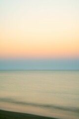 relaxing long exposure showing the sea at sunrise. Gold ocean beach sunrise.