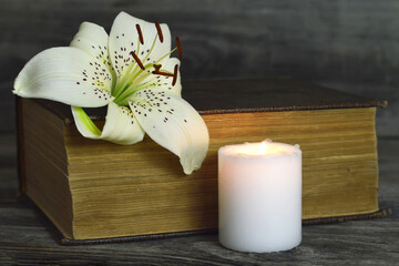 Sympathy card with white candle, lily flower and closed book