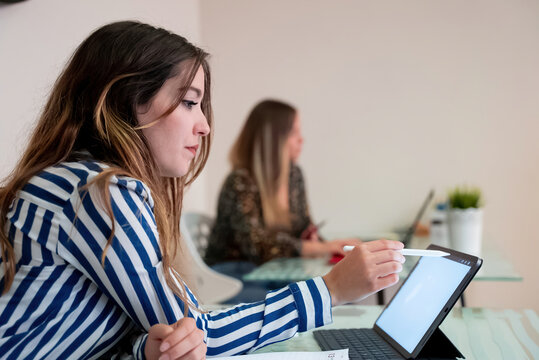 young girl working in the office with a tablet