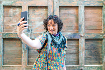 modern middle-aged woman taking a photo from her smartphone