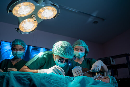 Group of surgeons working and examining the operation