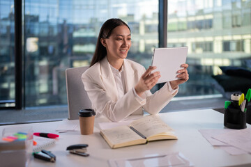 Asian businesswoman making video call in office