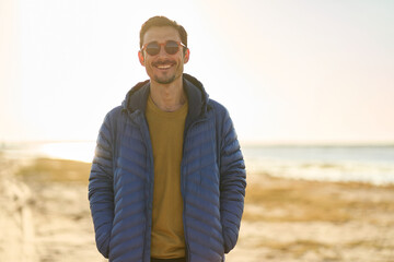 happy young man with sunglasses on the beach