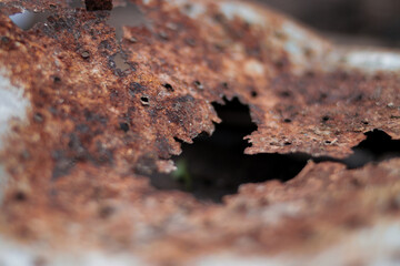 Defocused abstract background of rusty metal with holes