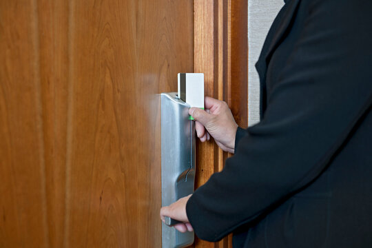 Woman opening hotel room with magnetic keycard