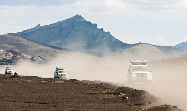 SUV's driving through the dusty interior of Iceland