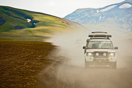 SUV's driving through the dusty interior of Iceland