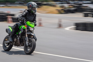 Woman practising on her motorbike at race track in Bangkok