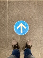 a person with arrow sign