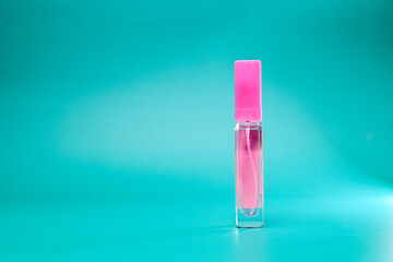 women's perfume in a transparent bottle on a lilac background