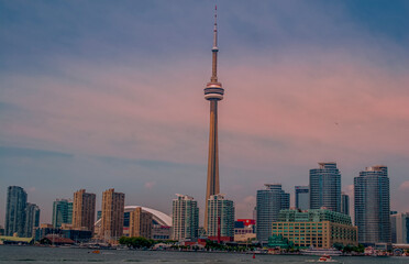 Toronto city skyline with CN tower the famous canadian landmark viewed from the lake at dusk