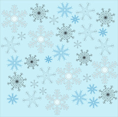 Black, blue, white and grey snowflakes covering enter frame, on top of pale blue background. Winter, seasonal, holidays.