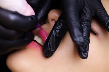 repeated tattooing procedure of the model to fix the colors and shades on the lips