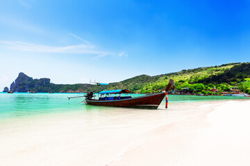 Fototapeta na wymiar Thai traditional wooden longtail boat and beautiful sand beach at Koh Phi Phi island in Thailand.