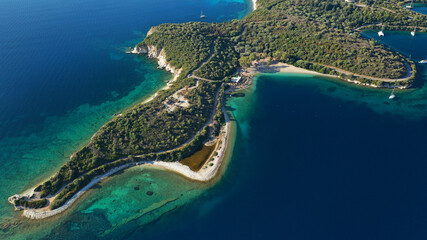 Aerial drone photo of organised with sunbeds and umbrelas paradise beach of Fanari with crystal clear turquoise sea, Meganisi island, Ionian, Greece