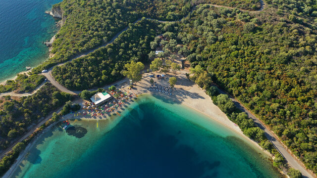 Aerial drone photo of organised with sunbeds and umbrelas paradise beach of Fanari with crystal clear turquoise sea, Meganisi island, Ionian, Greece