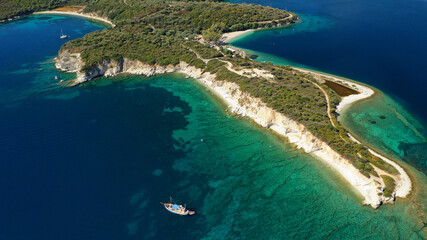 Aerial drone photo of organised with sunbeds and umbrelas paradise beach of Fanari with crystal...