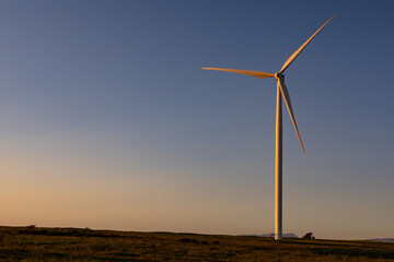 General view of wind turbine in countryside landscape during sunset - Powered by Adobe