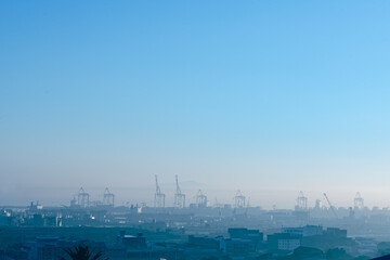 Obraz premium General view of cityscape with multiple modern buildings and cranes in the morning