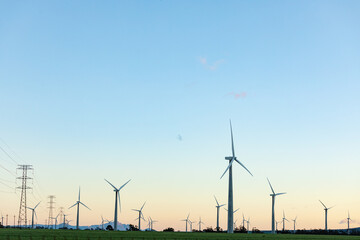 Obraz premium General view of wind turbines in countryside landscape with cloudless sky