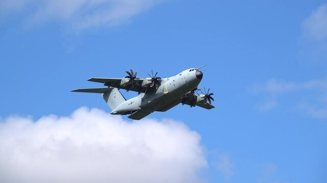 ZM401 RAF Royal Air Force Airbus A400M Atlas military cargo plane on a low-level cargo parachute drop battle exercise, blue sky scattered white cloud Wilts UK