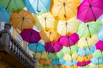 Fototapeta na wymiar Street decorated with colored umbrellas in Águeda, Portugal