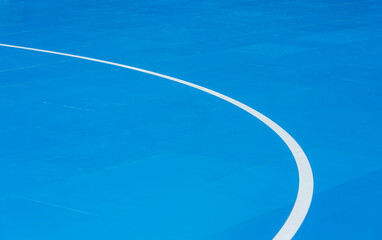 Blue floor volleyball, basketball, badminton, futsal, handball court. Wooden floor of sports hall with marking lines line on wooden floor indoor, gym court