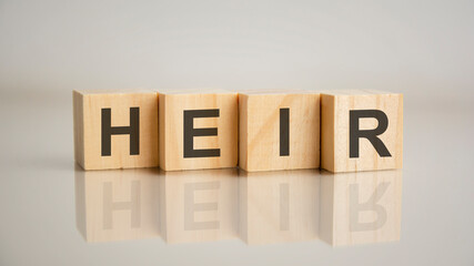 Four wooden cubes with letters heir. Business marketing concept