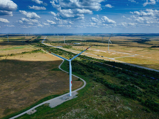 Wind turbines at the countryside in summer day, aerial view
