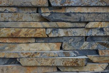 Inlaid cut stone wall inlaid and arranged forming a decorative residential pattern