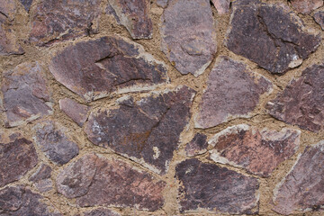 Tidy inlaid stone wall forming a decorative residential pattern
