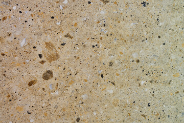 Rough stone texture with rust in blue and yellow colors with orange placed on a wall on a facade