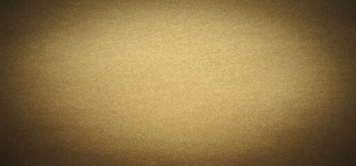 Photo of the texture of yellow craft paper, rectangular in shape with a dark vignette on the edges