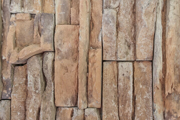 Inlaid cut stone wall inlaid and arranged forming a decorative residential pattern