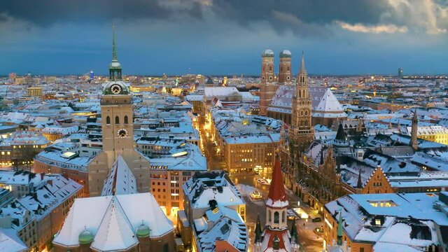 Marienplatz Munich aerial skyline aerial view at winter with snow old town, fly over town hall frauenkirche church, Munich in a bird's-eye view. The Marienplatz square. 