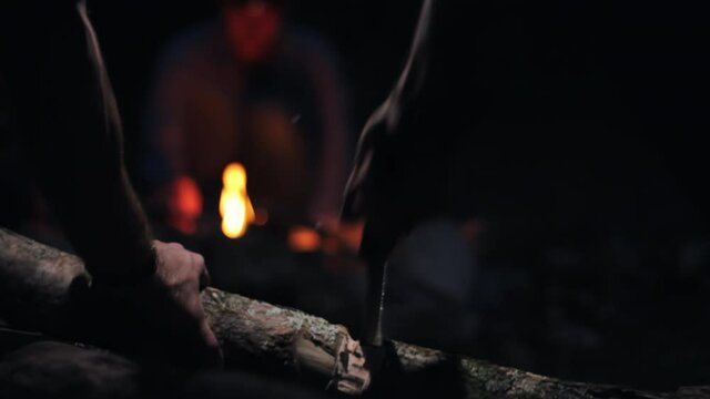 Campers Chop Wood At Night
