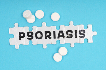 On a blue background pills and puzzles with the inscription - PSORIASIS