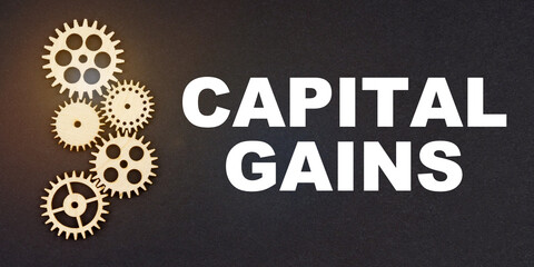 On a black background, gears and the inscription - CAPITAL GAINS