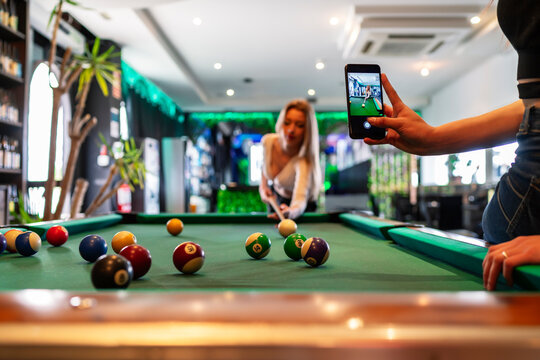 beautiful blonde girl playing pool