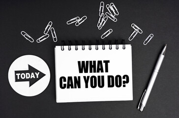 On a black background, a round plate - Today and a notebook with the inscription - What Can You Do