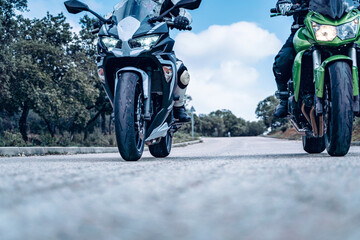 biker couple riding along a mountain road with their sport bikes